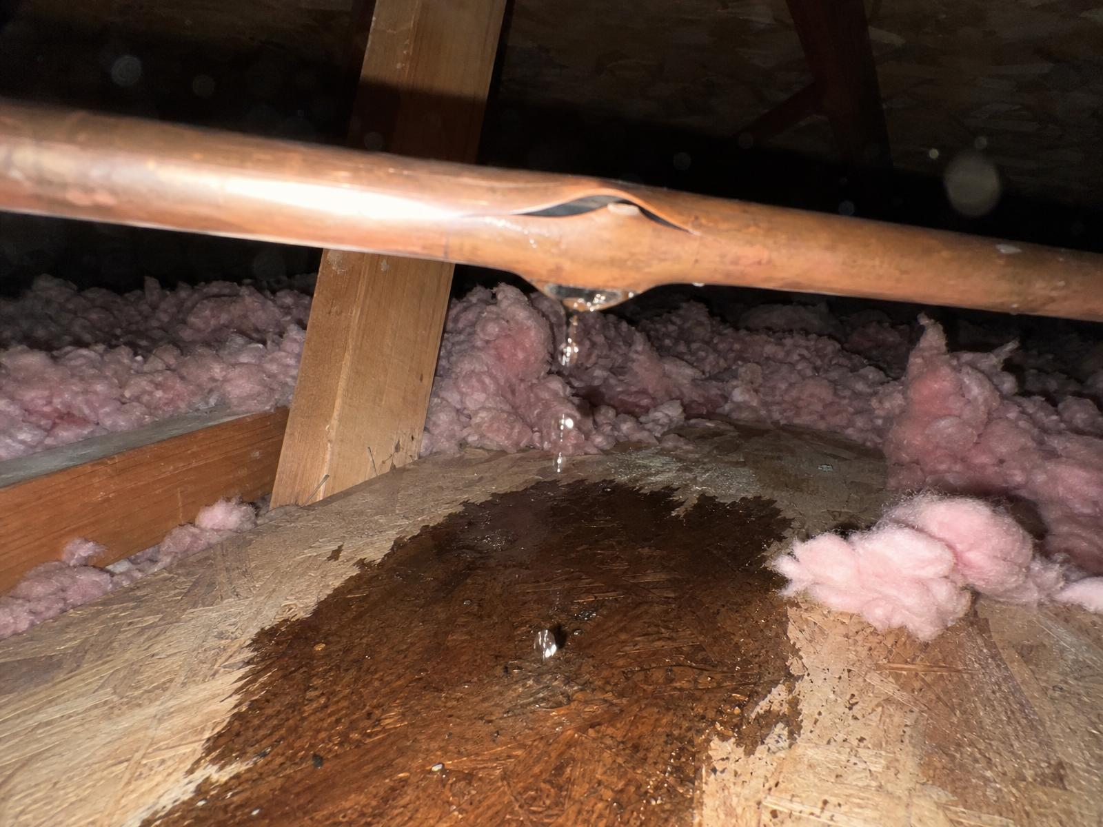 Split copper water line dripping onto attic insulation and plywood decking